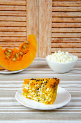 Rustic still life. Pumpkin curd pie, pumpkin slices and homemade cottage cheese in a white bowl.