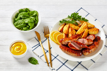 fried sausages on a plate with potatoes