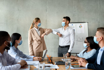 Pandemic Business Etiquette. Office Workers Bumping Elbows During Meeting In Conference Room