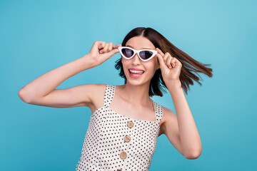 Photo of youth attractive woman good mood travel trip vacation eyewear isolated over blue color background