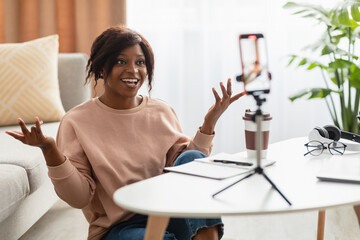 African American Female Blogger Using Phone Making Video At Home