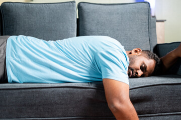 tired fat man sleeping on sofa at home - concept showing of resting, weekend holiday and exhausted...
