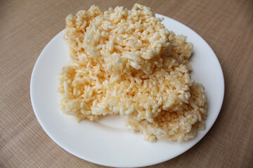 Rengginang, traditional crackers from Indonesia, made from sticky rice which dried then fried. On a white plate.