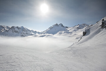 wonderful winter sports scene in the alps. with snowboard and ski in fantastic mountain panorama...