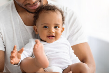 Fototapeta na wymiar Portrait Of Adorable Black Baby Boy Spending Time With Father At Home