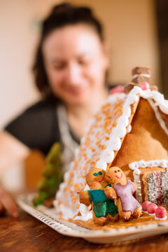 A decorated homemade gingerbread house with figurines