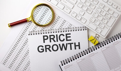 Fototapeta premium PRICE GROWTH text written on notebook on chart with keyboard and planning