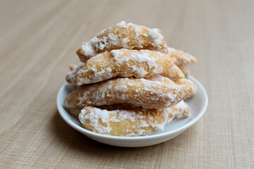 Widaran manis, also called telur gabus manis. Indonesian traditional snack. Fried dough then glazed with melted sugar. Wooden background.