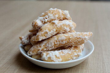 Widaran manis, also called telur gabus manis. Indonesian traditional snack. Fried dough then glazed with melted sugar. Wooden background.