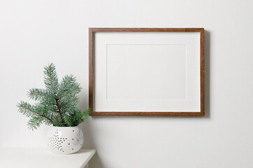 Frame mockup with copy space for artwork, photo or print presentation. White wall interior with...