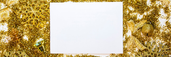 Christmas background with gifts, gold ribbon and gold Christmas decorations, glitter. Christmas background, top view. Copy space. Banner.
