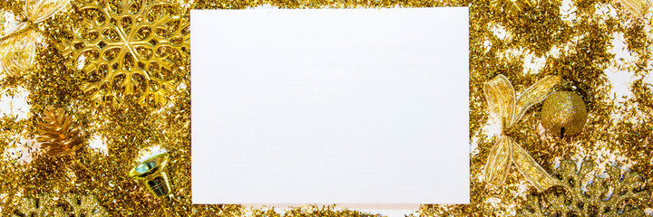 Obraz premium Christmas background with gifts, gold ribbon and gold Christmas decorations, glitter. Christmas background, top view. Copy space. Banner.