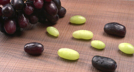 Natural organic different types of fresh ripe juicy grapes and space for text on table. top view, Agriculture concepts.