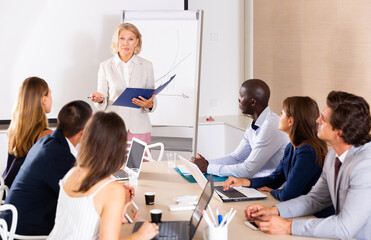 Business woman making presentation on staff meeting at office