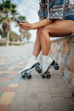 Anonymous roller skater browsing smartphone
