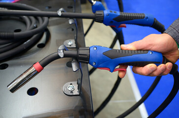 Man hand holding welding semi automatic gun for welder