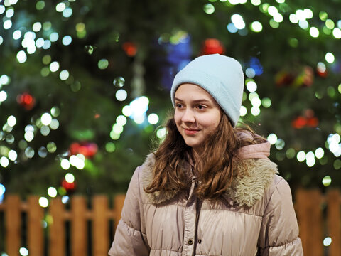 Authentic tenage girl in front of a Christmas tree