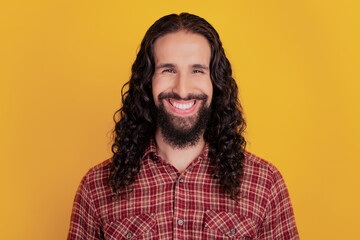 Photo of cheerful candid man toothy beaming smile wear checkered shirt isolated on yellow color background