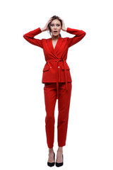 High fashion photo of a beautiful elegant young woman in a pretty red suit, jacket, pants, trousers posing over white background. Slim figure. Studio Shot. Businesswoman