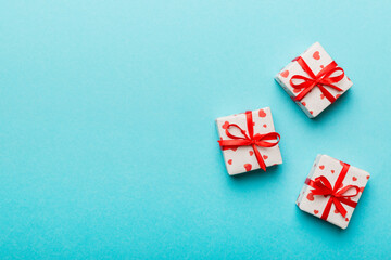 Valentine day composition: red gift box with bow and heart. Christmas present. View from above. Space for text. Holday greeting card