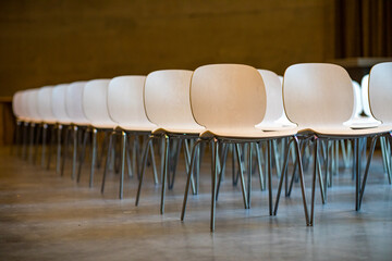 Wooden conference hall chairs nicely aligned 