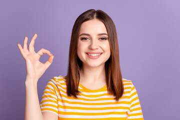 Photo of young cheerful girl show finger okey symbol choose promotion isolated over violet color background