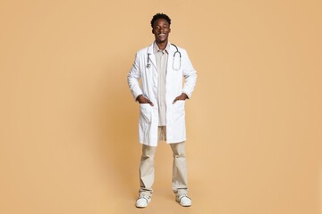 Fototapeta na wymiar Portrait Of Smiling Young African American Doctor Wearing Uniform And Stethoscope