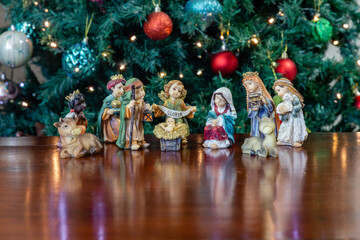 Traditional Christmas nativity scene with Christmas tree and flashing lights in the background, Christmas nativity scene in fine detail, Christmas background