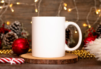 Obraz na płótnie Canvas Coffee mug mockup with red christmas decorations. 11oz White mug branding Mockup. Christmas imprint