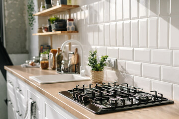 Kitchen in white tones with stove, sink and shelves - obrazy, fototapety, plakaty