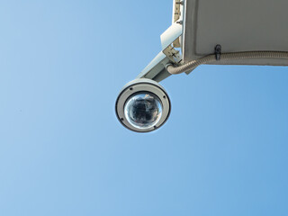 360 Degree fish eye dome CCTV installed under the building balcony against blue sky. CCTV for security monitoring with space for place your text.