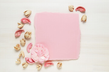 Tender floral frame on a light wooden background