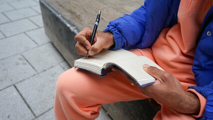 Fototapeta premium Close up of man writing in diary
