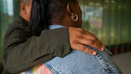 Rear view of two women embracing