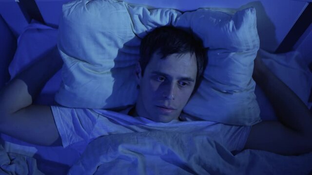 Man cannot sleep from the noise of neighbors