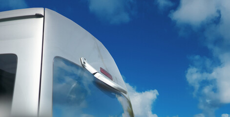 back car reflex mirror on blue sky background