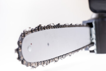 Close up of the new chain of a chainsaw. Isolated on white