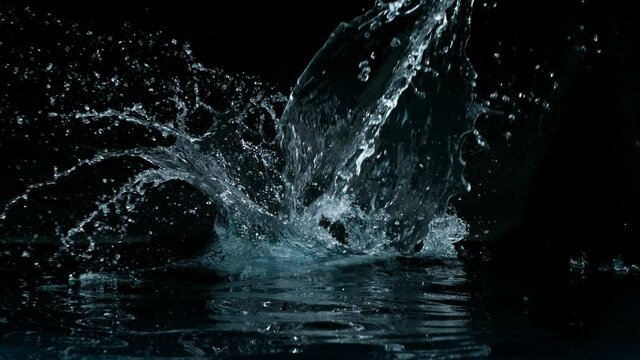 Super slow motion of big water splash on black background. Filmed on high speed cinema camera, 1000 fps.