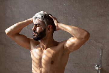 Handsome young Arabic male model enjoying taking hot shower