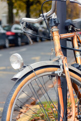 Fototapeta na wymiar vintage orange bicycle in the street