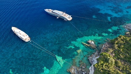 Aerial photo of luxury sail boat anchored in tropical Caribbean rocky turquoise colour seascape