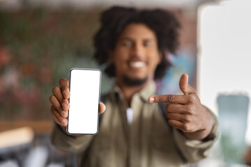 Check This. Closeup Shot Of Black Guy Pointing At Blank Smartphone Screen