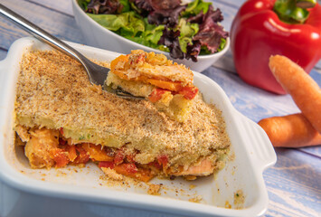 Salmon Parmentier recipe with hazelnuts, young salad leaves
