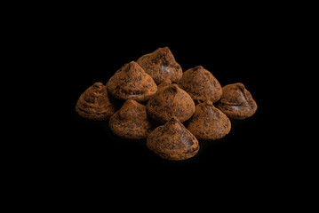Chocolate truffles on a black background.