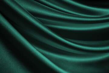 Blue green silk satin. Soft, wavy folds. Shiny fabric surface. Luxurious emerald green background...