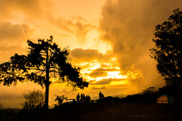 Silhouettes of tourists are watching the sunset  in Doi mae taman. The famous attractions of Thailand.