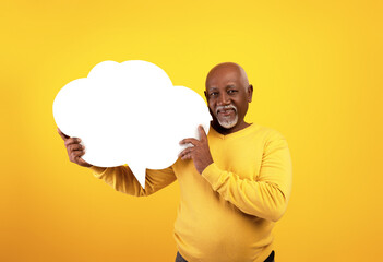 Senior black man holding empty speech bubble on orange studio background, mockup - obrazy, fototapety, plakaty