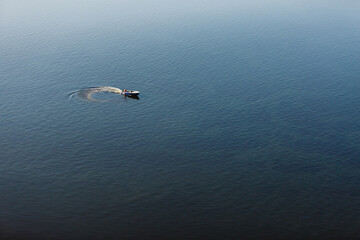 fishing boat floats on the river