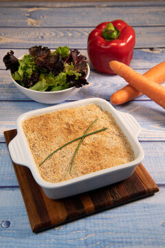 Salmon Parmentier recipe with hazelnuts, young salad leaves. High quality photo