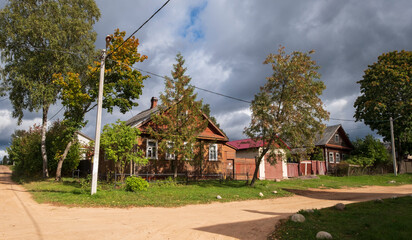 Cozy village streets with old wooden houses in the town of Tikhvin, Russia in summer